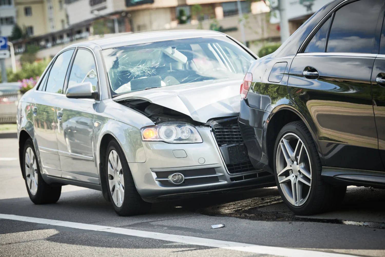 Two-car collision on a road showing front-end smash damage